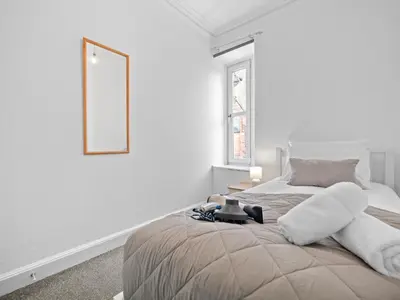 a white bedroom with a bed and a mirror at Ludgate 2 Bedroom Apartment - Alloa in Alloa