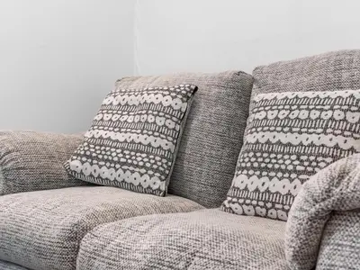 a gray couch with two pillows on it at Ludgate 2 Bedroom Apartment - Alloa in Alloa