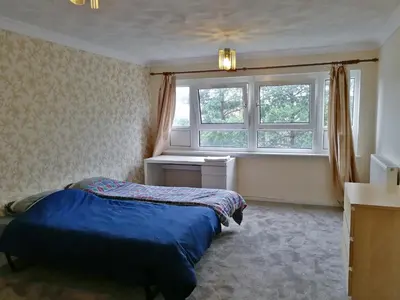a bedroom with a bed in front of a window at Three Bedroom Apartment Glasgow in Glasgow