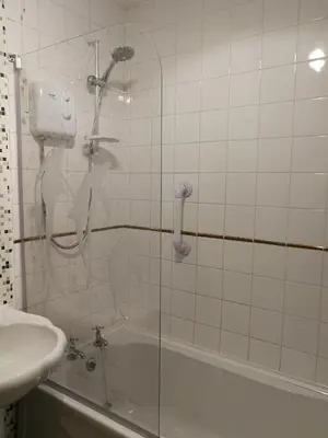 a shower in a bathroom with a sink and a tub at Three Bedroom Apartment Glasgow in Glasgow