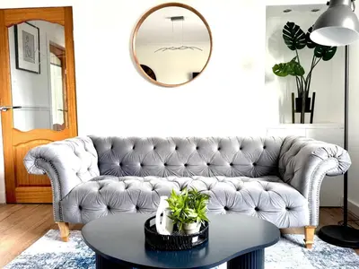 a living room with a couch and a table at Newtown Hideaway in Boʼness