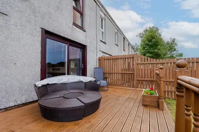 a wooden deck with a bench on top of a house at 2 Bedroom House-Free Parking in Rosyth