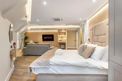 a bedroom with a large bed and a living room at City Centre Luxury Studio for 2 in Edinburgh