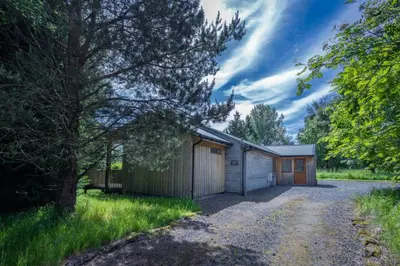 a house with a garage and a driveway at Ben Lawers Rest Cabin - Hot Tub and Loch Tay Vistas in Lawers