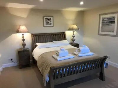 a bedroom with a bed with towels on it at Ben Lawers Rest Cabin - Hot Tub and Loch Tay Vistas in Lawers