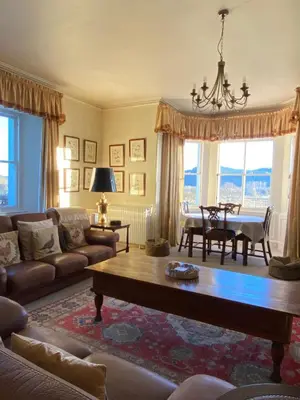 a living room with a couch and a table at Fordie Lodge in Comrie