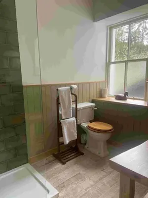 a bathroom with a toilet and a glass shower at Fordie Lodge in Comrie