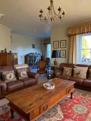 a living room with a couch and a coffee table at Fordie Lodge in Comrie