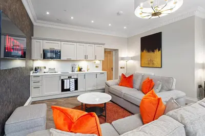 a living room with a couch and a table at Prime Central Edinburgh 2 bed in Edinburgh
