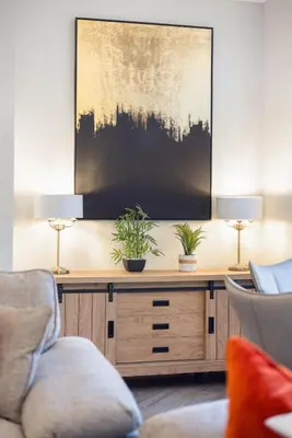 a living room with two lamps and a tv at Prime Central Edinburgh 2 bed in Edinburgh