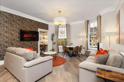 a living room with two couches and a table at Prime Central Edinburgh 3 bed in Edinburgh