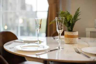 a table with plates and wine glasses on it at Prime Central Edinburgh 3 bed in Edinburgh