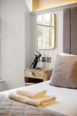 a bedroom with a bed with a window and a telescope at Prime Central Edinburgh 3 bed in Edinburgh