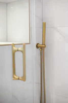 a shower with a gold handle in a bathroom at Prime Central Edinburgh 3 bed in Edinburgh