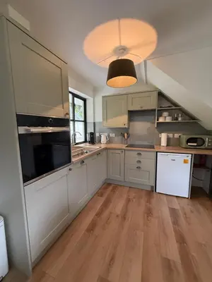 a kitchen with white cabinets and a white refrigerator at Highland Nook in Fort William