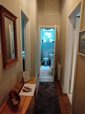 a hallway with a bathroom with a toilet in it at Lovely flat in Gorgie, Edinburgh in Edinburgh