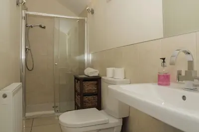 a bathroom with a toilet and a sink and a shower at Oak Cottage and Hot Tub, Loch Tay in Lawers