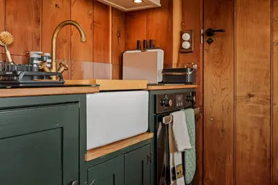 a kitchen with a stove and a sink and a counter at Quercus & Redwood - Sleeps 4 in Moffat