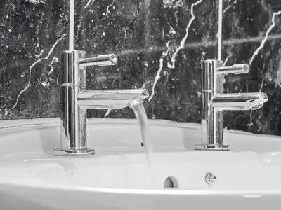 a bathroom sink with two faucets on it at Mollison 2 Bedroom Apartment - Harthill in Harthill