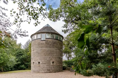 a brick lighthouse with a window on top of it at Retreat to the Water Tower in Queensferry
