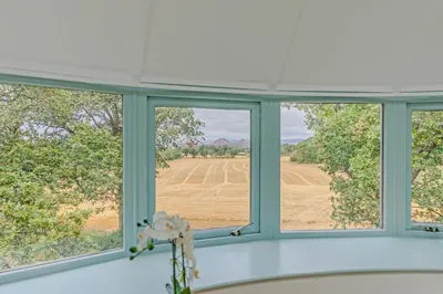 a window in a room with a view of a field at Retreat to the Water Tower in Queensferry