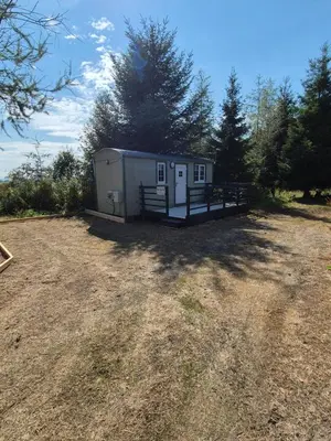 a small shed in the middle of a field at Blair snug hut 2 in Kelty