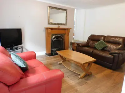 a living room with a couch and a coffee table at Cosy 2 Bed Apartment in Crossford near Lanark in Crossford