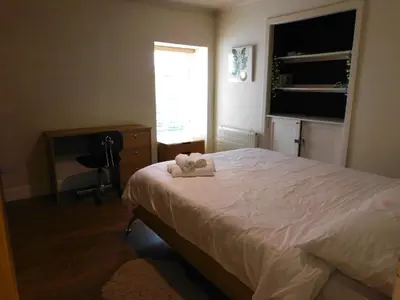 a bedroom with a bed with two towels on it at Cosy 2 Bed Apartment in Crossford near Lanark in Crossford