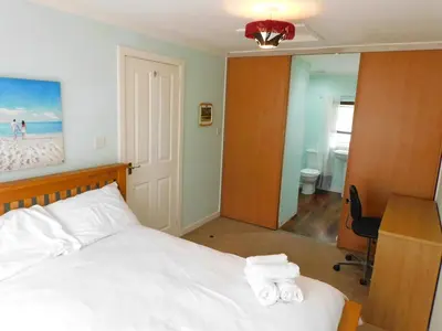 a bedroom with a bed with towels on it at Cosy 2 Bed Apartment in Crossford near Lanark in Crossford