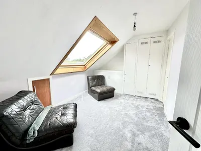 a living room with a couch and a window at Avenue Cottage, Inveraray in Inveraray