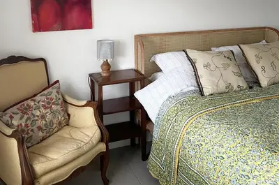 a bedroom with a bed and a chair and a lamp at Old Schoolhouse in Inveraray