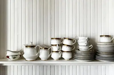 a shelf with a bunch of dishes and cups and plates at Old Schoolhouse in Inveraray