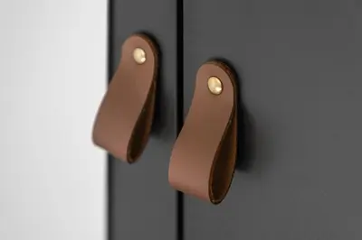 a pair of wooden handles on a black door at Kirkstyle Cottage in Coatbridge