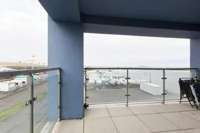 a balcony with a view of a parking lot at Waterfront Spacious Flat in Edinburgh