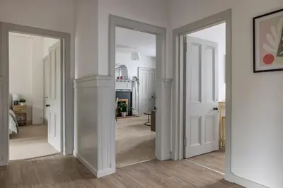 an open hallway with white walls and white doors at Antonine Quarters in Grahamston
