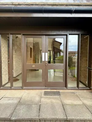 an entrance to a house with glass doors at Cosy apartment near Edinburgh city centre in Edinburgh