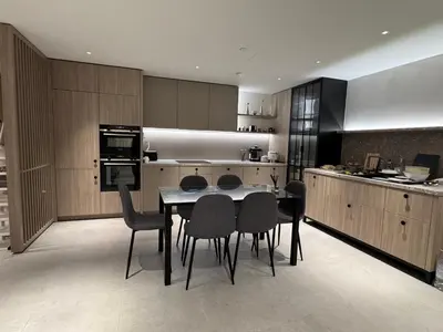 a kitchen with a table and chairs in it at Modern Serviced Apartment in Kings Cross Central London in Moffat