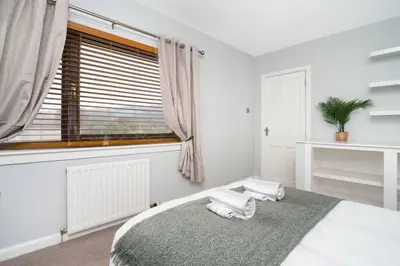 a white bedroom with a large bed with a window at Wardlaw Retreat-WiFi-Parking in Oakley