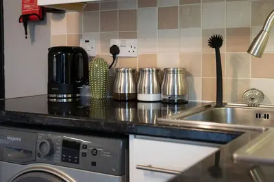 a kitchen counter top with a sink and a stove at Wardlaw Retreat-WiFi-Parking in Oakley