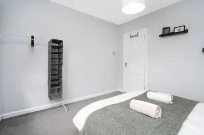 a bedroom with white walls and a bed with two pillows at Wardlaw Retreat-WiFi-Parking in Oakley