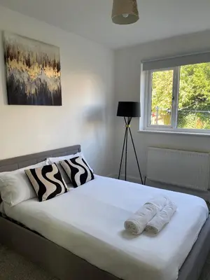 a bedroom with a bed with two towels on it at Glasgow City Apartment with 2 Bedrooms in Glasgow