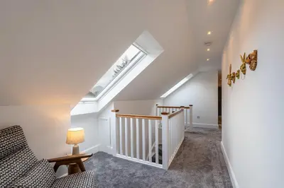 a staircase with a skylight in a house at Strathfillan Lodge in Crianlarich