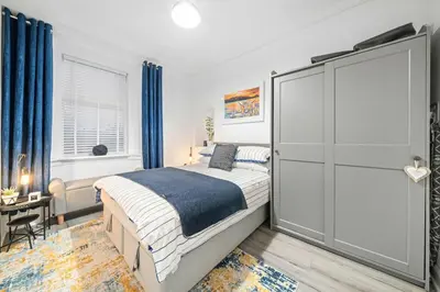 a bedroom with a king sized bed and a desk at Couples or Golfers Near to Beach in Troon