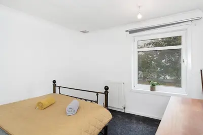 a bedroom with a bed and a window at 3BR Family House with Free Parking in West Lothian in Whitburn