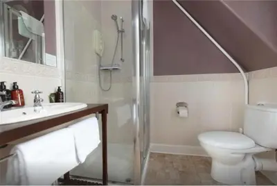 a bathroom with a shower and a toilet and a sink at Camus House, Lochside Guest House in Onich
