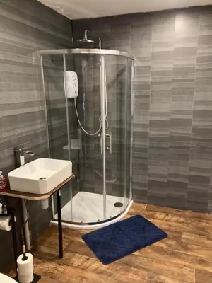 a bathroom with a shower and a sink at The Tartan Sheep in Kilmarnock