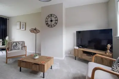 a living room with a large flat screen tv at Gray House-Modern 2BR close to Loch Lomond in Alexandria