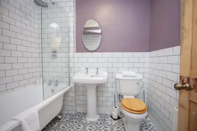 a bathroom with a toilet and a sink and a tub at 1 Bed Cosy Loch Lomond base in Bonhill