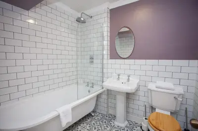 a bathroom with a sink and a tub and a toilet at 1 Bed Cosy Loch Lomond base in Bonhill