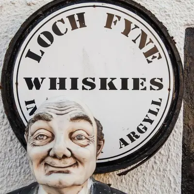 a clock on a wall with a bust of a man at Lochfyne-View Apartment in Inveraray